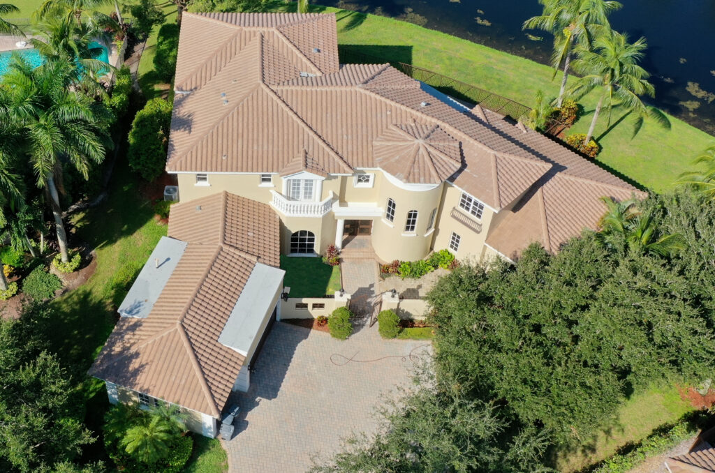 Large home on waterfront with recent tile roof job completed by bravo's roofing